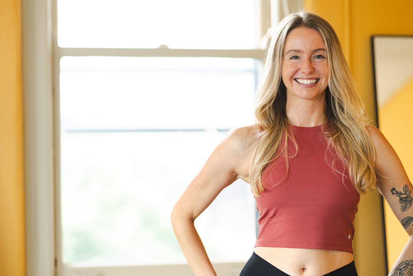 Caroline smiling by the window in her studio