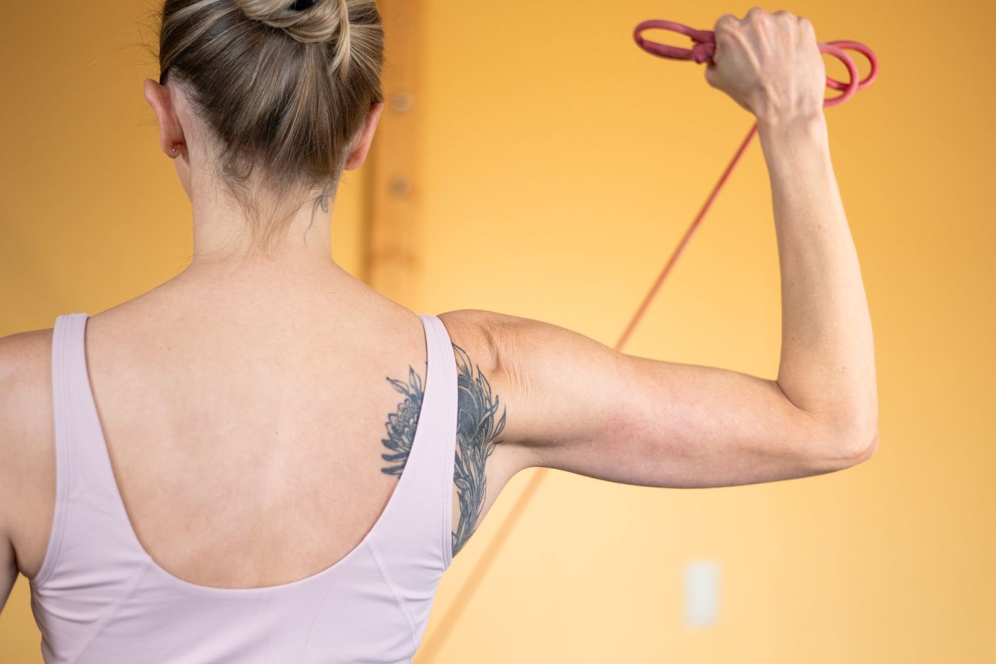 Caroline working a resistance band for shoulder strength
