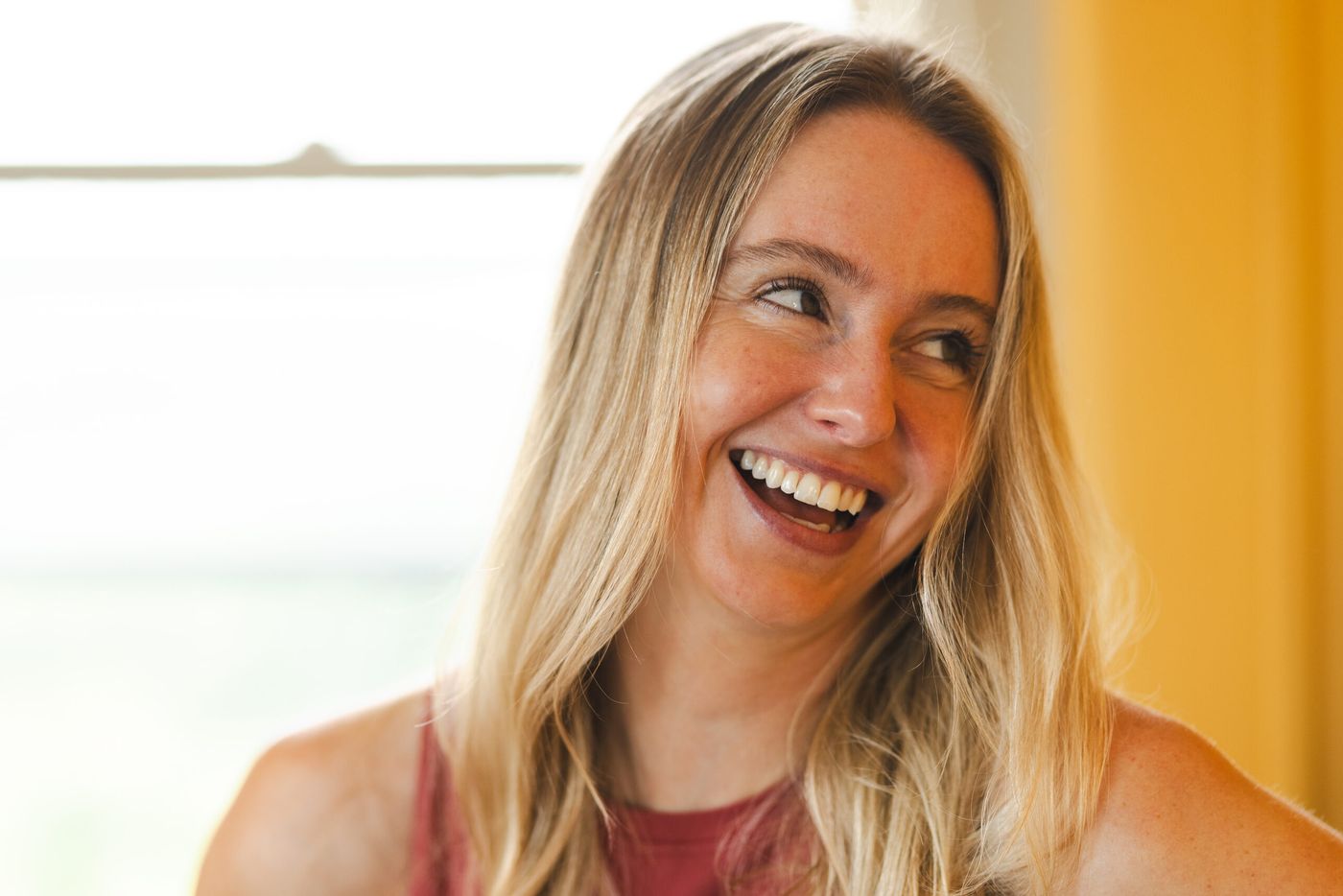 Caroline laughing with her hand on her hip
