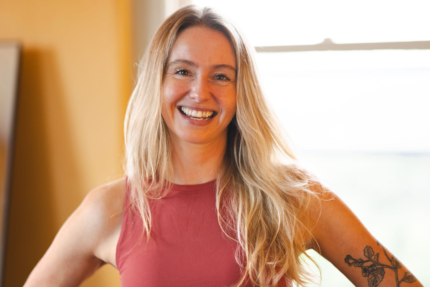 Caroline smiling by a sunlit window